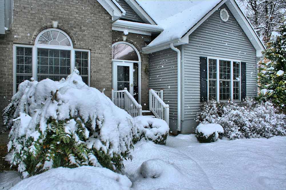 House covered in snow after a winter storm